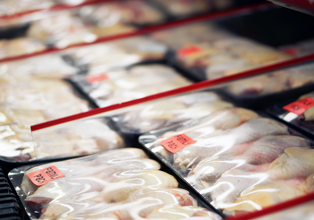 Frozen poultry in a display case.