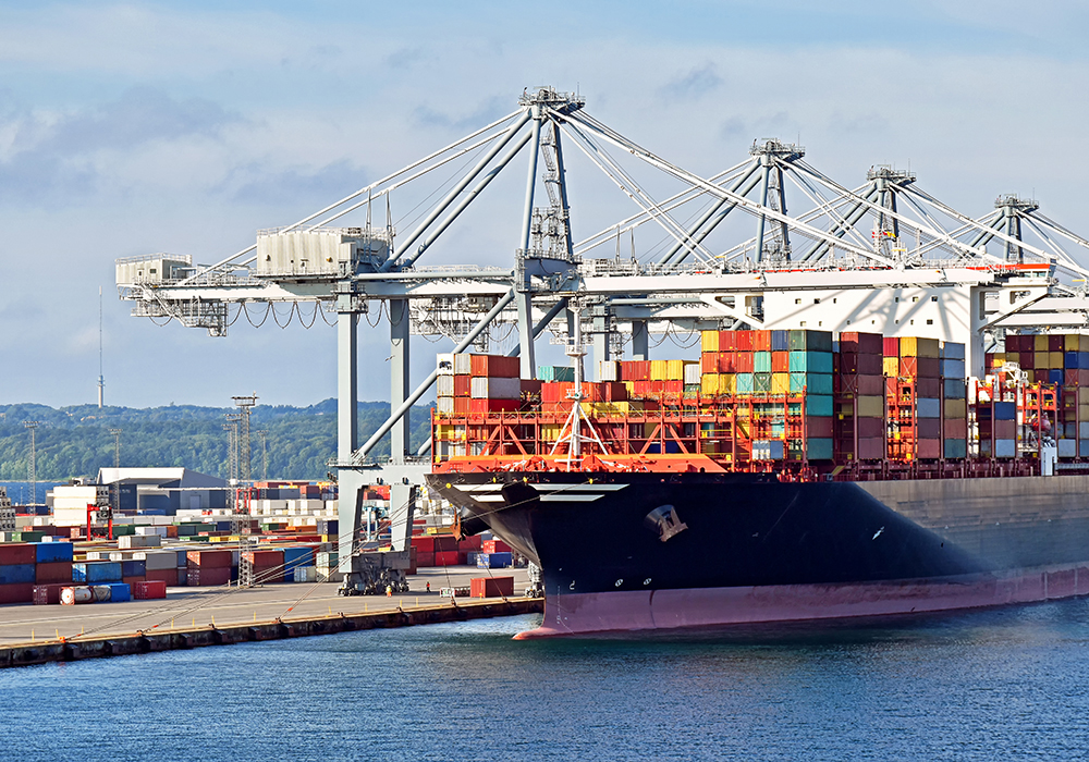 A container ship sits loaded at the dock.