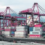 A loaded container ship sits at the doc on the Port of Vancouver.