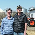 Gaylord and Lois Mierau pose with their arms around one another on their farm near Saskatoon.