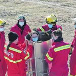A member of the Cardston, Alta., fire department stands inside a “grain dam” as fellow rescue personnel learn the technique of extracting a person trapped in grain.
