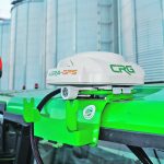 A GPS satellite receiver is mounted to the roof of a tractor.
