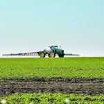 A sprayer in the distance shot from ground level.
