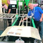 A salesman demonstrates a Proposition 12 compliant pig enclosure on the trade show floor during the World pork Expo in Des Moines, Iowa.