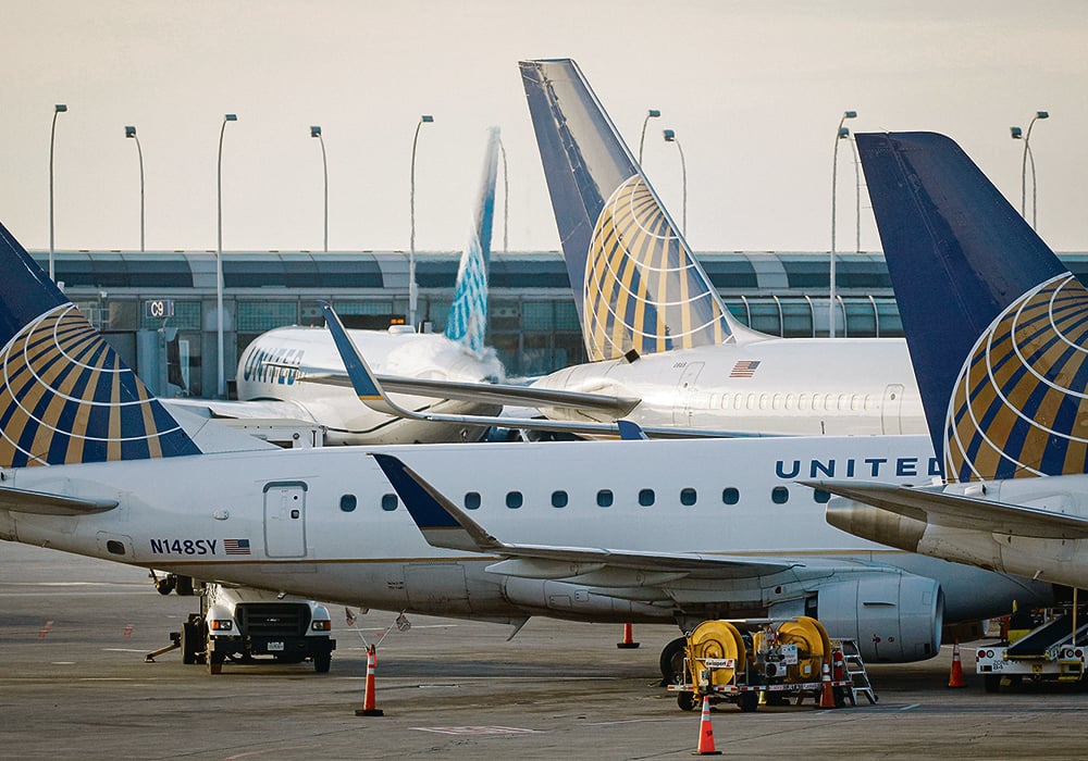 Passenger planes parked at the gates of a major airport.