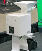 A desktop grain sampler sits on a table.