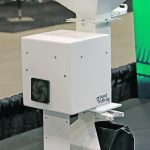 A desktop grain sampler sits on a table.