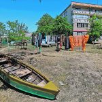A boat sits in the yard of an apartment building after floodwaters receded following the collapse of the Nova Kakhovka dam in Ukraine.