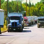 Grain trucks are lined up to deliver crop to an inland elevator facility.
