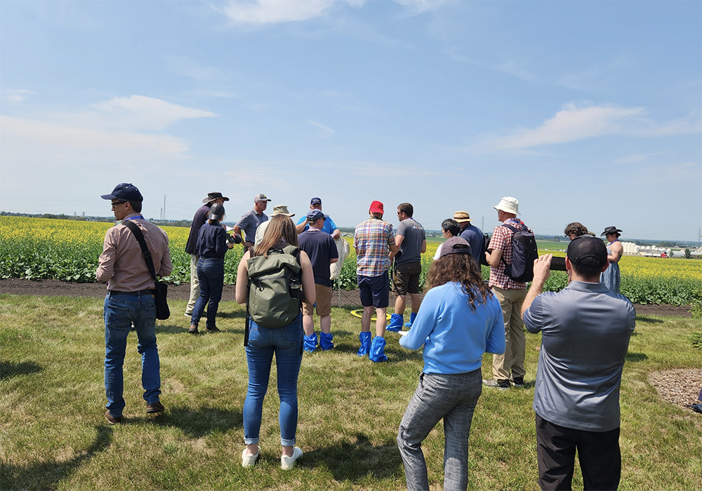Journalists from arround the world check out a canola field during a crop tour as part of the recent International Federation of Agricultural Journalists' conference.