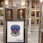 Portraits of men in suits can be seen lining the walls, with several more on display stands in the foreground, in the entrance way to the Agricultural Hall of Fame.