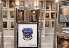 Portraits of men in suits can be seen lining the walls, with several more on display stands in the foreground, in the entrance way to the Agricultural Hall of Fame.