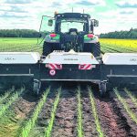 The three 10-foot covers prevent ambient sunlight from entering the spraying chamber. The Ecorobotix uses its own light source so the algorithms always know what their light waves signify. The covers can run anywhere from a few inches off the ground to three feet for taller crops such as cereals. The side benefit is that the sprayer can work in windy conditions that can ground conventional sprayers. | Ecorobotix photo