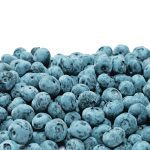 A pile of fresh blueberries against a white background.