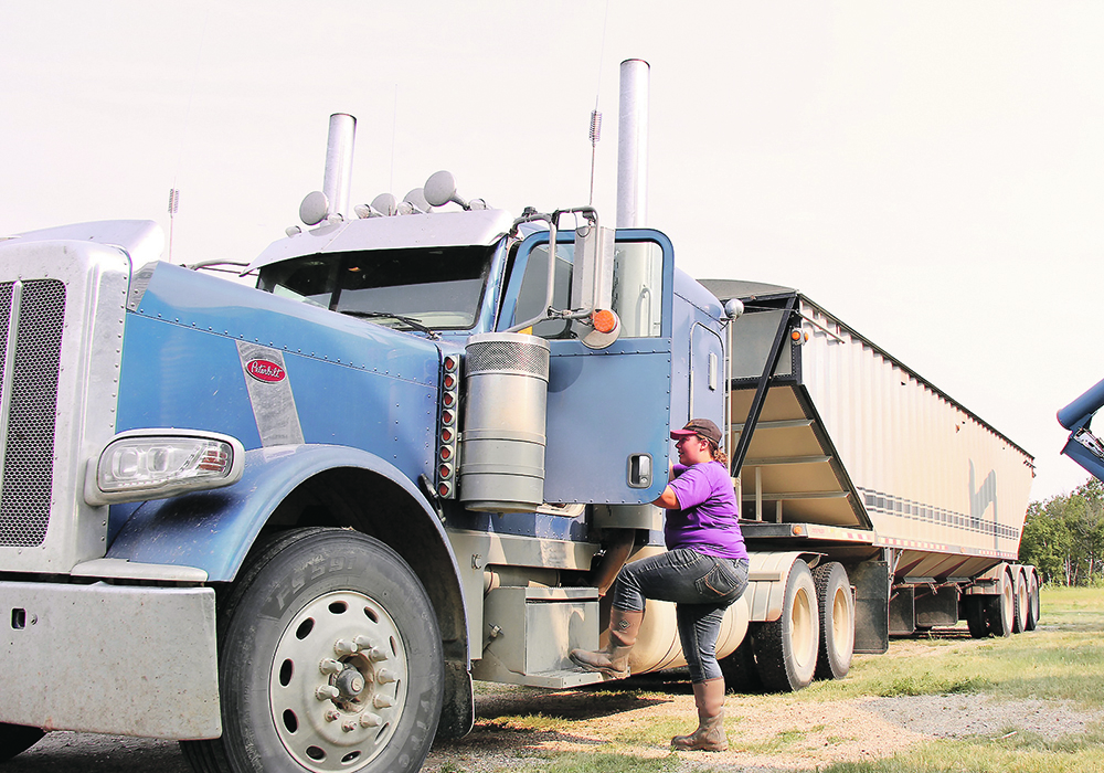 Leanne Kotylak climbs into her truck.