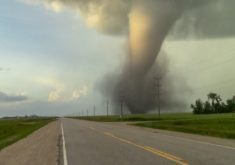 A tornado touches down next to a highway in Manitoba.