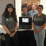 Kashika Sethi (left) and Rhea Thomas Thommana (right) were at Ag in Motion to represent the Department of Food and Bioproduct Science, and to show some of the ongoing projects at the University of Saskatchewan including the pea-based “chicken leg” seen in the machine.