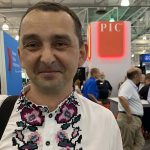Portrait of Yaroslavl Bondar at Pork Expo wearing traditional Ukrainian embroidered shirt.