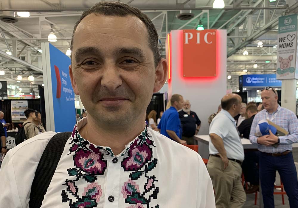 Portrait of Yaroslavl Bondar at Pork Expo wearing traditional Ukrainian embroidered shirt.