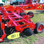 a bright red disc cultivator with packers attached to the back.