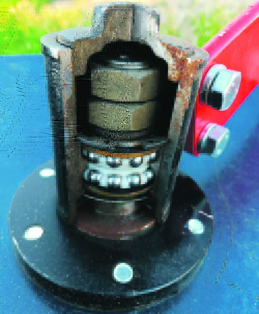 A disc hub with a section cut away to reveal the large nuts on the shaft end and the bearings inside the hub