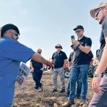 Farmers from Brazil’s Agraria co-operative listen to Sam Abourjelly explain his company’s rock crusher while they attended the Ag in Motion farm show held in July near Langham, Sask. | Ed White photo