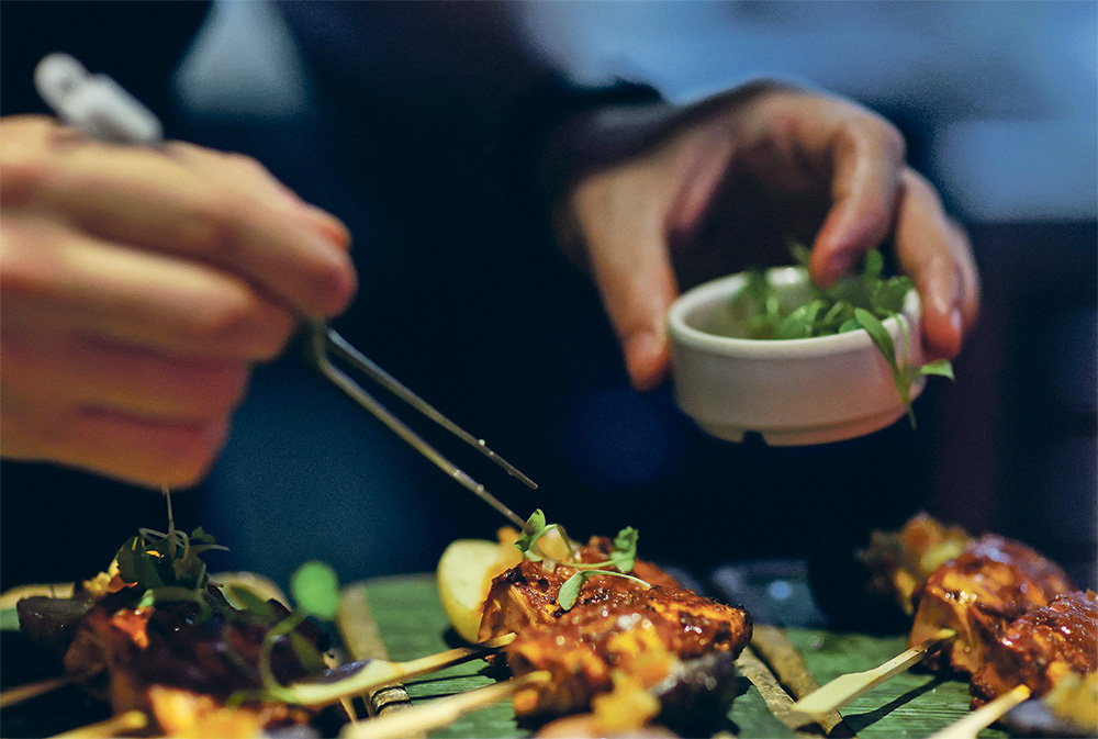 A chef plates lab-grown chicken from Good Meat that he grilled at a restaurant in Washington, D.C. last month. As cell-cultivated meat starts to appear on menus after receiving regulatory approval, investors see sector expansion as the next hurdle. | Reuters/Leah Millis photo