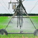 A photo of pivot irrigation watering a field.