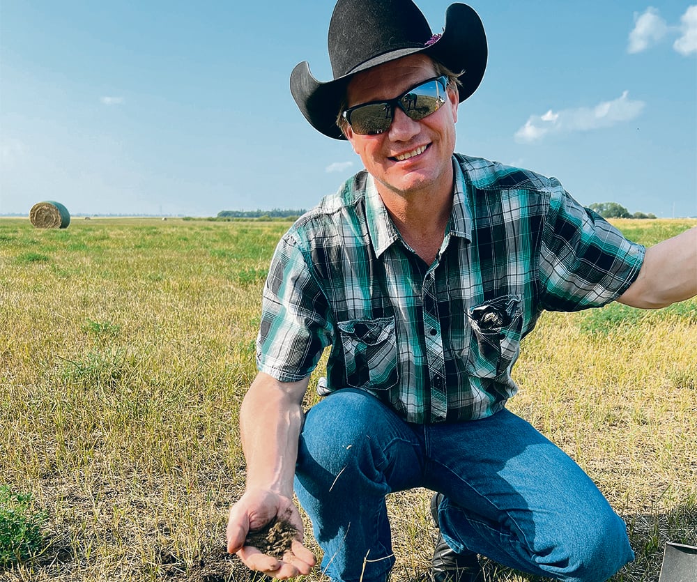 Steve Kenyon had a close look at the soil at Steven Balzer’s pasture near Langham, Sask.  |  Laura Rance photo