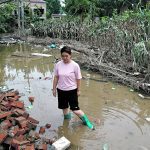 Wang Dan stands in floodwaters near a damaged corn farm in a village in Zhuozhou in China’s Hebei province Aug. 7 following rain and floods brought on by remnants of Typhoon Doksuri. | Reuters/Tingshu Wang photo
