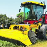 A new yellow windrower with a narrow header.