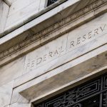 A photo of the facade of the U.S. Federal Reserve building.