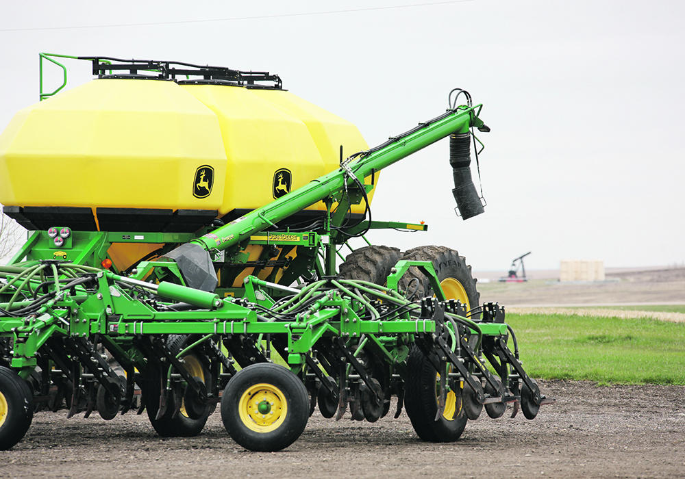 A John Deere air seeder sits idle.