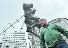 Derek Johnson of AGI in front of his company’s display site at Ag in Motion.  |  Ed White photo