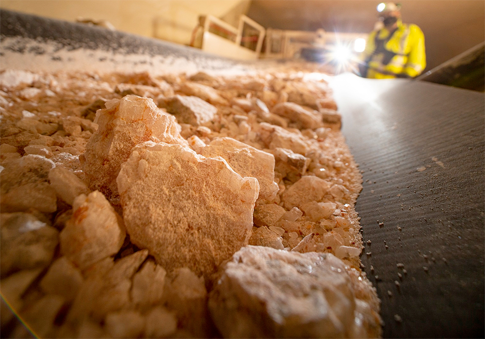 Potash moves along a conveyor belt in a Mosaic mine.