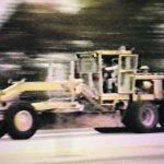 Screen image from a video taken during a high-speed test, in which engineers had a grader travel up to 70 m.p.h., proving the durability of rubber belts. | Ron Satzler collection photo