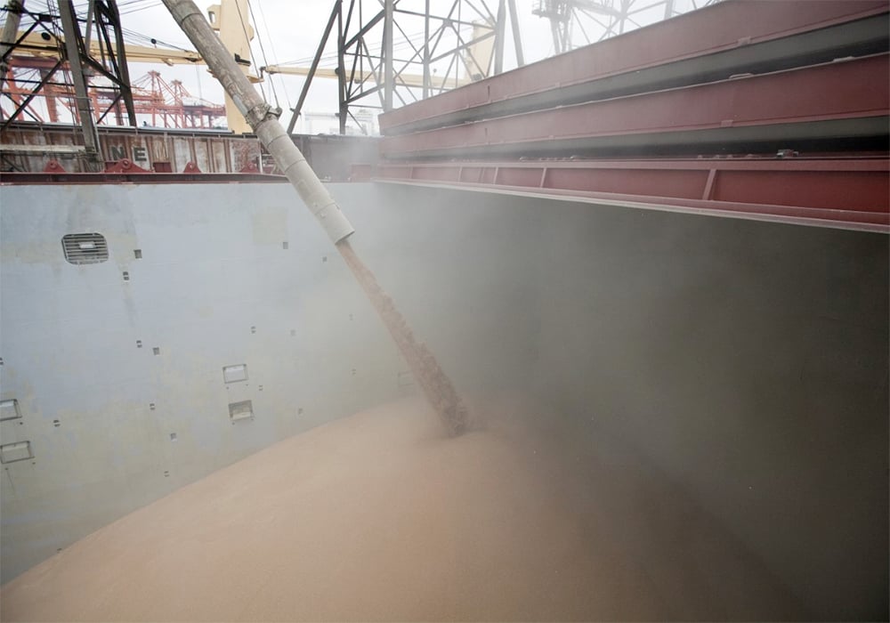 Wheat is loaded into the hold of a bulk container ship.