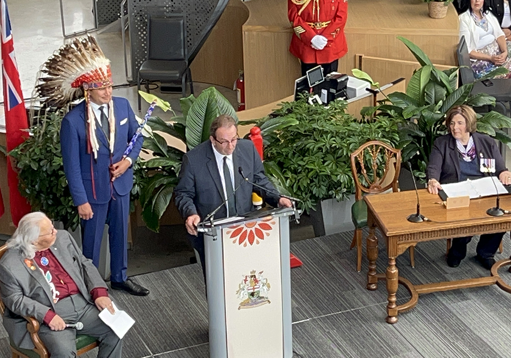 Manitoba premier Wab Kinew listens as new agriculture minister Ron Kostyshyn speaks Wednesday during the swearing-in ceremony for the new government. | Ed White photo