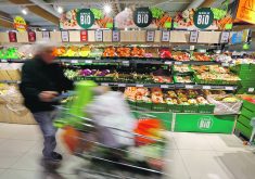 A customer pushes a shopping cart past organic products at the Bio fruits and vegetables section in a supermarket in Gattierese, France.  |  Reuters/Eric Gaillard photo