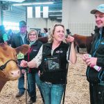 Blair, left, and Lois McRae of Mar Mac Farms southwest of Brandon look on as daughter Melissa and son Tyson chat before entering the show ring. The McRaes are one of the few farms at this year’s show that have been showing for 50 years. | Sandy Black photo