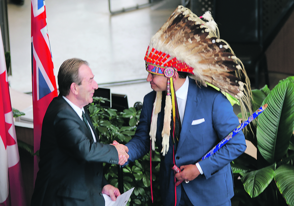 Manitoba agriculture minister Ron Kostyshyn, left, and premier Wab Kinew shake hands during Kostyshyn’s swearing in last month. The new ag minister says rural economic development is critical to the health of the sector in the province.  |  Ed White photo