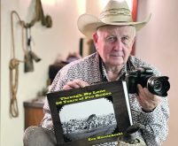 Ken Marcinkoski holds his camera and a new book surrounded by his collection of rodeo and camera antiques.  |  Mary MacArthur photo