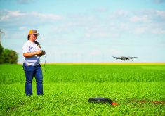 University of Saskatchewan graduate student Kaylie Krys pilots a drone over a Saskatchewan field. She and colleague Erik Andvaag have developed proof-of-concept of a method to rapidly scout fields for canola germination and presence of weeds. Photo:  Chris Hendrickson/University of Saskatchewan