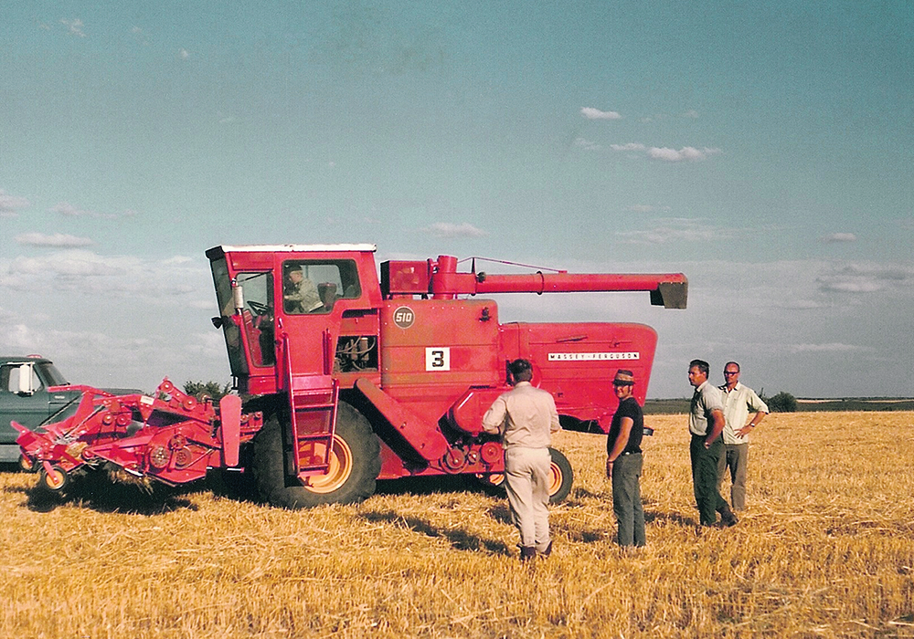 Engineers working on field trials with a 510 combine, circa 1960s. | Ray Bianchi collection photo