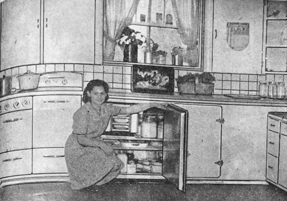 A modern kitchen in the farm home of R. Allard from St. Francois Xavier, Man., is featured in the Nov. 10, 1949 issue of The Western Producer. The kitchen boasts an electric stove, refrigerator and quick freeze unit. Mr. Allard’s daughter points out the storage capacity of the kitchen refrigerator. | Betty Ann Deobald photo