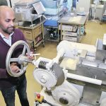 Sijo Joseph adjusts the settings on a machine that’s used to make oat flakes. He is part of a team of Agriculture Canada scientists who are studying oat protein and its potential benefits for human health. | Robert Arnason photo