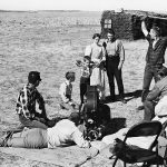 A film crew shoots a scene with the actors playing the pioneer Greer family in Drylanders. The sod house in the background was built for the film on the Thierman farm near Webb, Sask. | Photo courtesy of the National Film Board of Canada