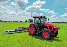 A Kubota M5 tractor equipped with the Sabanto autonomy system mows on a sod farm.  |  Sabanto photo