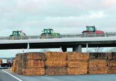 French farmers block a highway near Paris Jan. 30 with their tractors, hay bales and tents during a protest over price pressures, taxes and environmental regulation, grievances shared by producers across Europe.  |  Reuters/Abdul Saboor photo