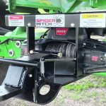 The Spider Hitch is mounted on equipment including combines. With the use of a synthetic tow rope, part of the hitch is pulled away from the vehicle and connected to a trailer. The trailer is pulled toward the mounted hitch with a winch, which allows one person to hook up without backing a vehicle toward a trailer. | Photo supplied by Spider Hitch